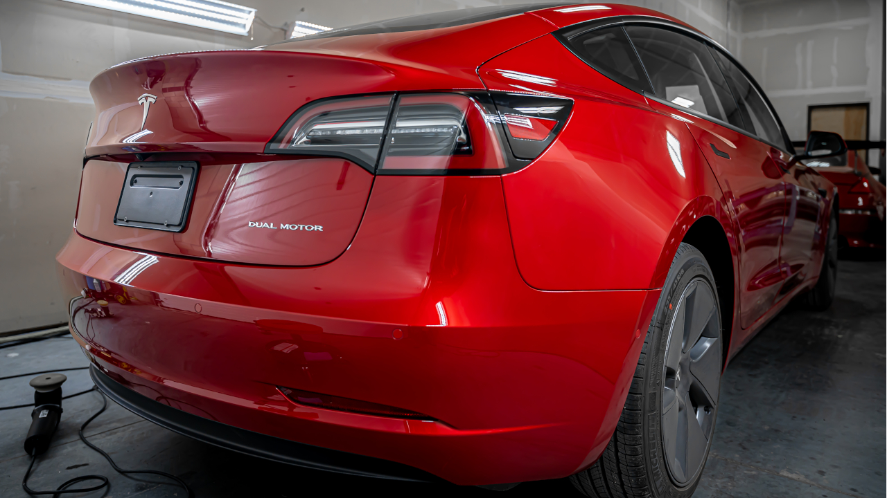 The back end of a red Tesla with ceramic coating