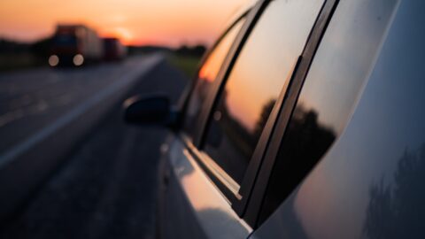 Tinted car window at sunset