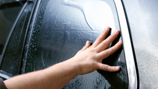 window tinting foil being applied to car